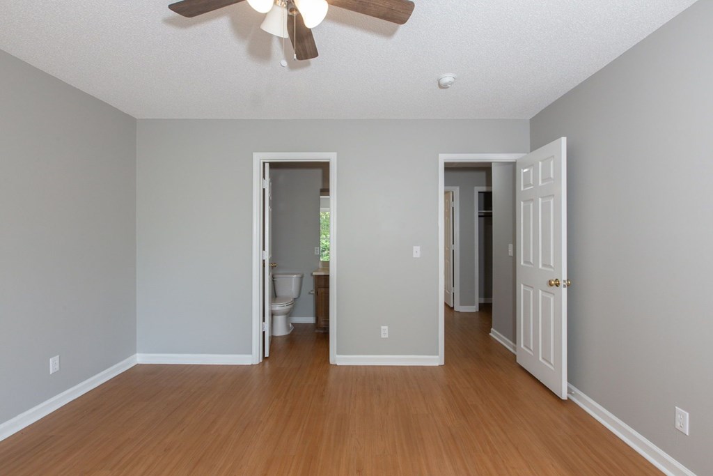 3660 Maryland Circle, Unit C Columbus, GA 31907 - Photo 3 of 21 an empty room with wooden floor chandelier fan and windows
