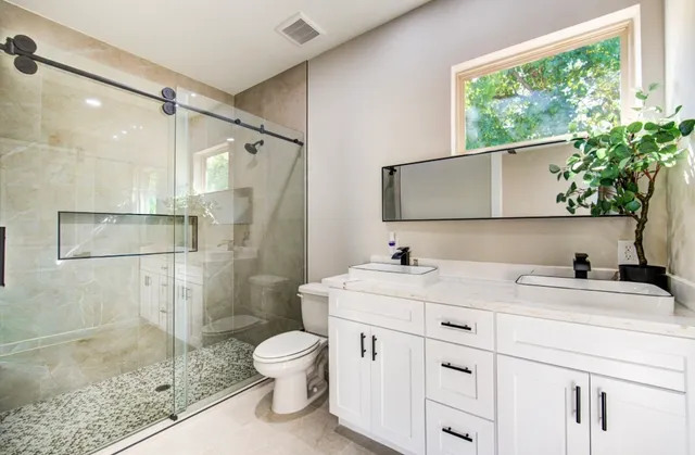 a bathroom with a sink toilet and shower