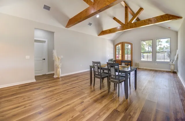 a view of a dining room with furniture and wooden floor