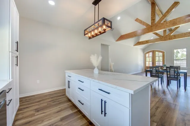 a view of a room with furniture and wooden floor