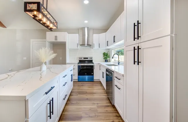 a kitchen with cabinets a sink and appliances