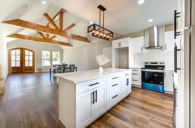 a kitchen with stainless steel appliances granite countertop a stove and a refrigerator