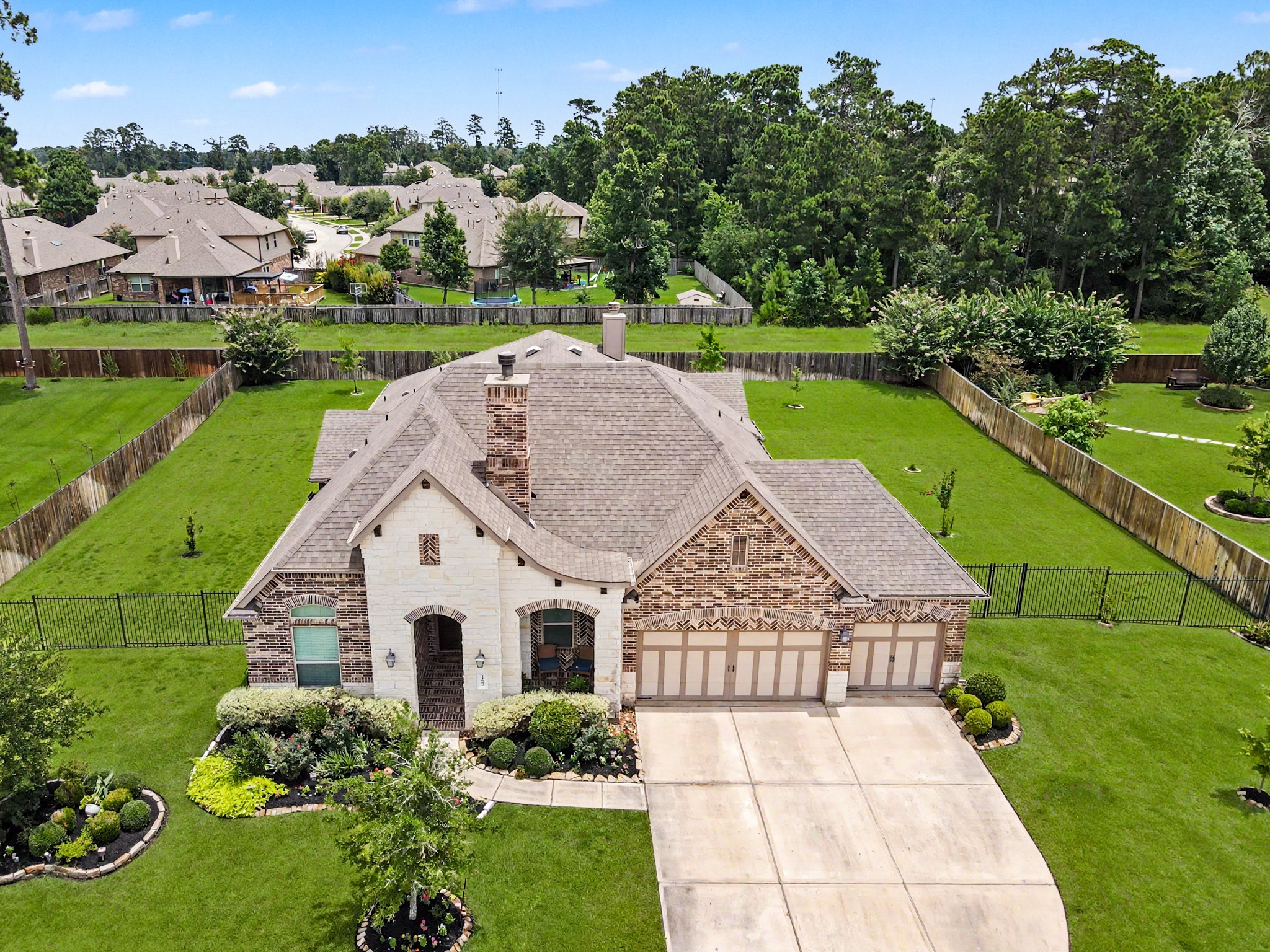 14003 South Evergreen Ridge Court Conroe, TX 77384 - Photo 3 of 43 Rare 135' wide homesite with no direct rear neighbors and exceptional backyard privacy.