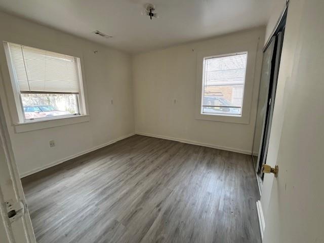 1119 Canton Road Marietta, GA 30066 - Photo 5 of 10 a view of an empty room with wooden floor and a window