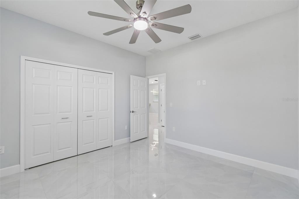 6018 Newmark Street Spring Hill, FL 34606 - Photo 12 of 26 an empty room with chandelier fan