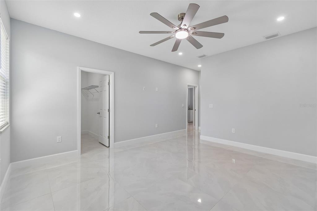 6018 Newmark Street Spring Hill, FL 34606 - Photo 15 of 26 an empty room with a ceiling fan and a window