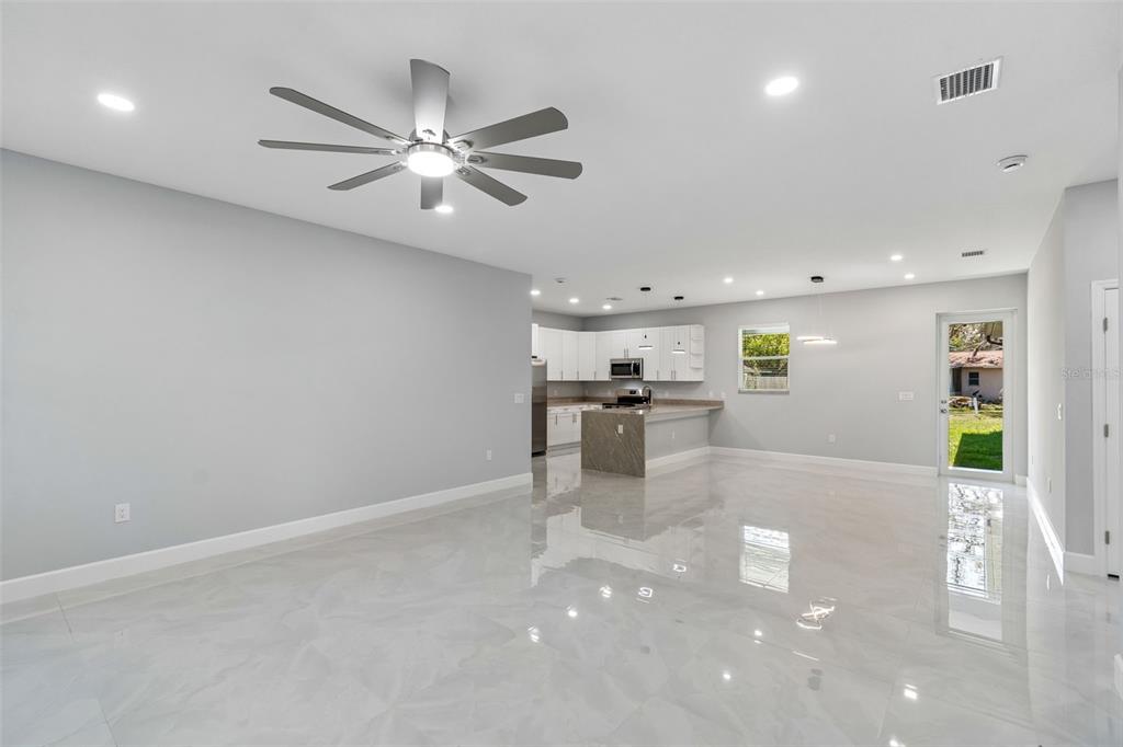 6018 Newmark Street Spring Hill, FL 34606 - Photo 2 of 26 a view of a kitchen with a sink stainless steel appliances and cabinets