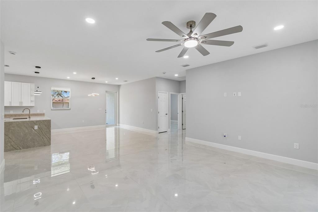 6018 Newmark Street Spring Hill, FL 34606 - Photo 3 of 26 a view of an empty room with cabinet and a ceiling fan