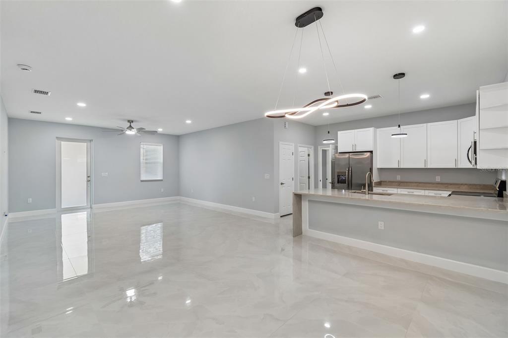 6018 Newmark Street Spring Hill, FL 34606 - Photo 4 of 26 a kitchen with stainless steel appliances a refrigerator and a sink