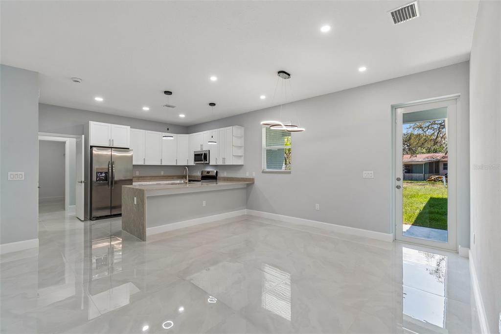 6018 Newmark Street Spring Hill, FL 34606 - Photo 5 of 26 a kitchen with stainless steel appliances kitchen island sink refrigerator and stove