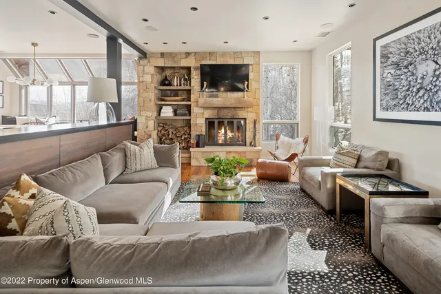 a living room with furniture fireplace and a flat screen tv