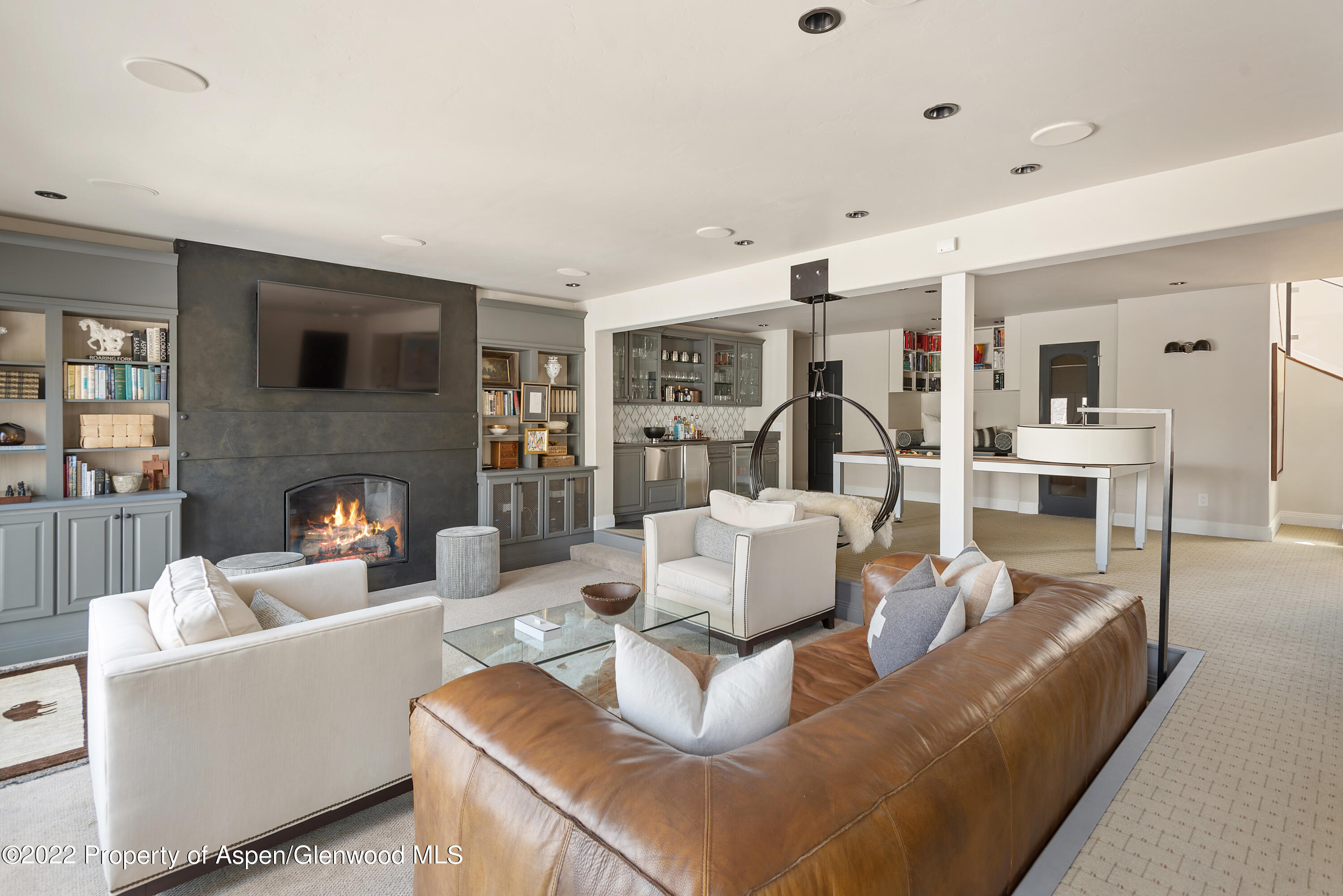 399 Maple Ridge Lane Snowmass Village, CO 81615 - Photo 14 of 27 a living room with furniture and a fireplace