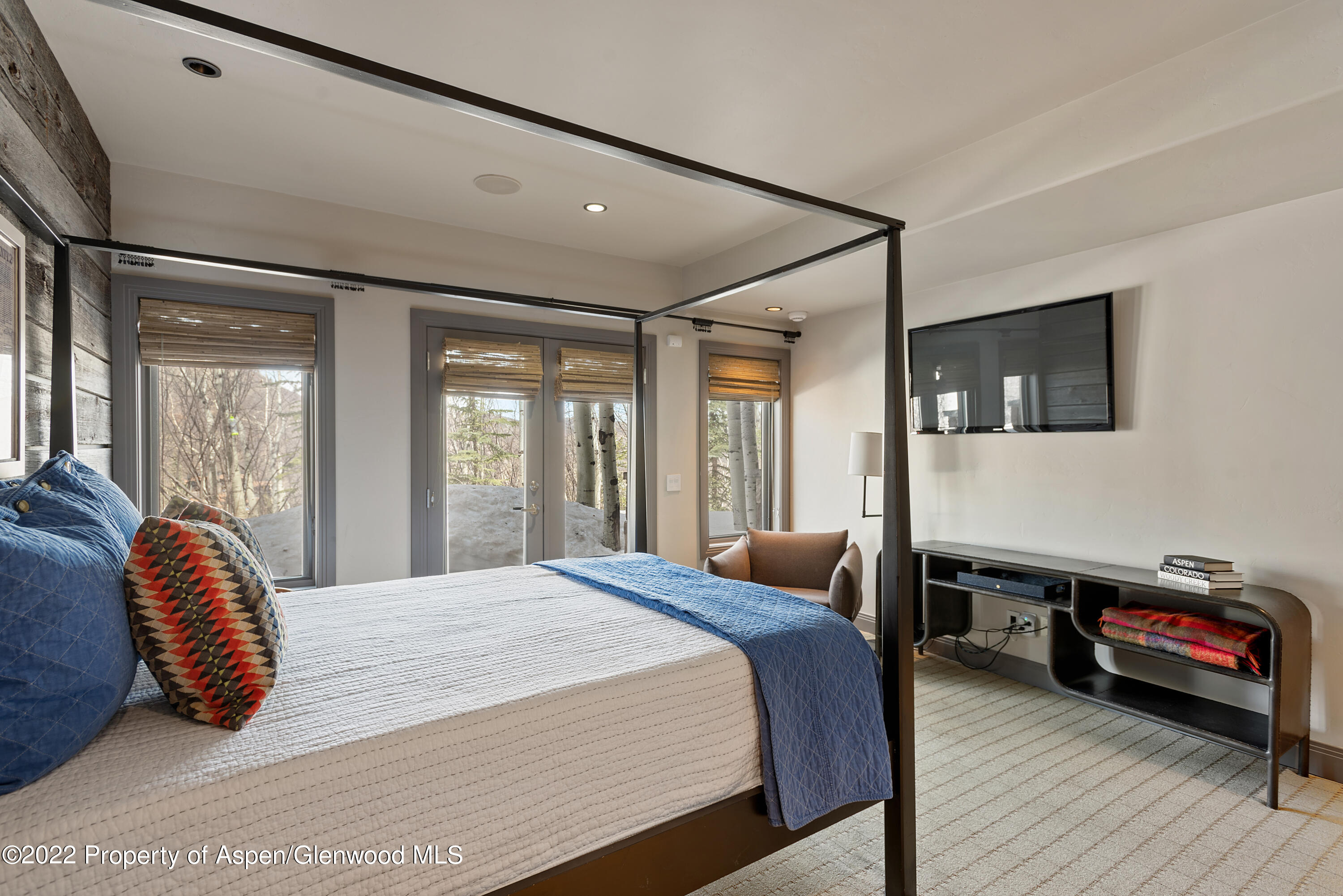 399 Maple Ridge Lane Snowmass Village, CO 81615 - Photo 17 of 27 a bedroom with a large bed and a large window