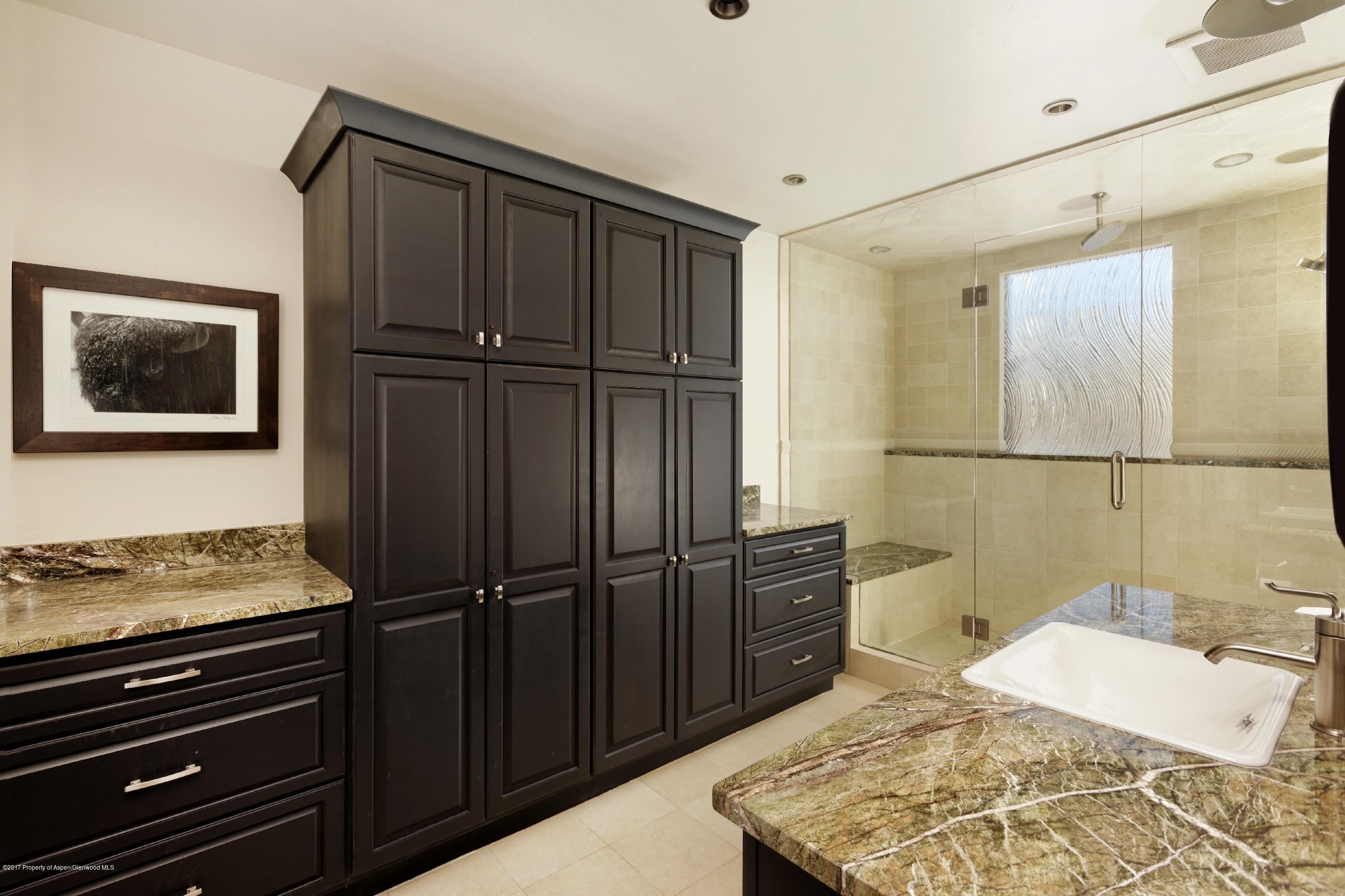 399 Maple Ridge Lane Snowmass Village, CO 81615 - Photo 18 of 27 a bedroom with a bed and cabinets