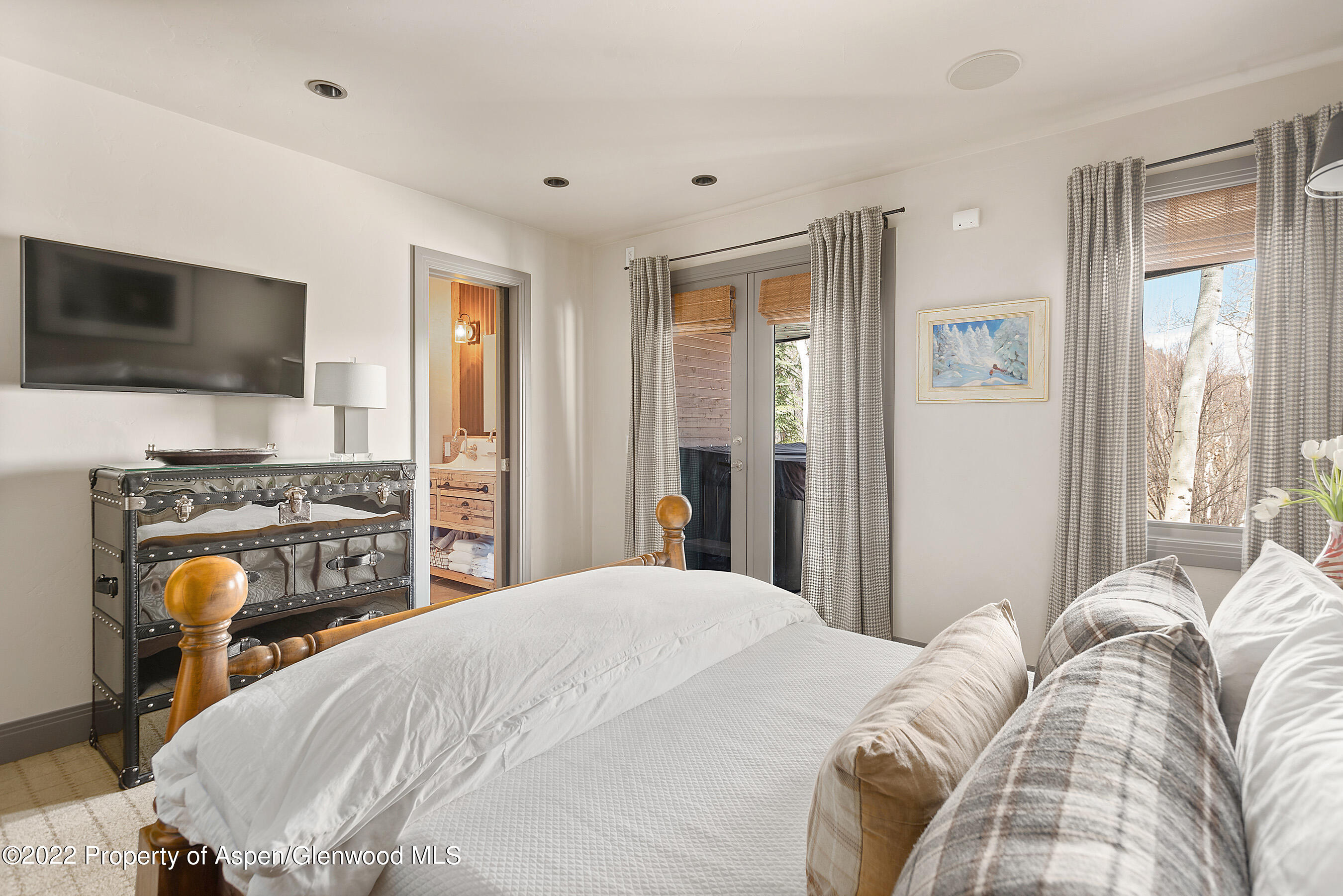 399 Maple Ridge Lane Snowmass Village, CO 81615 - Photo 21 of 27 a bedroom with a bed and a flat screen tv