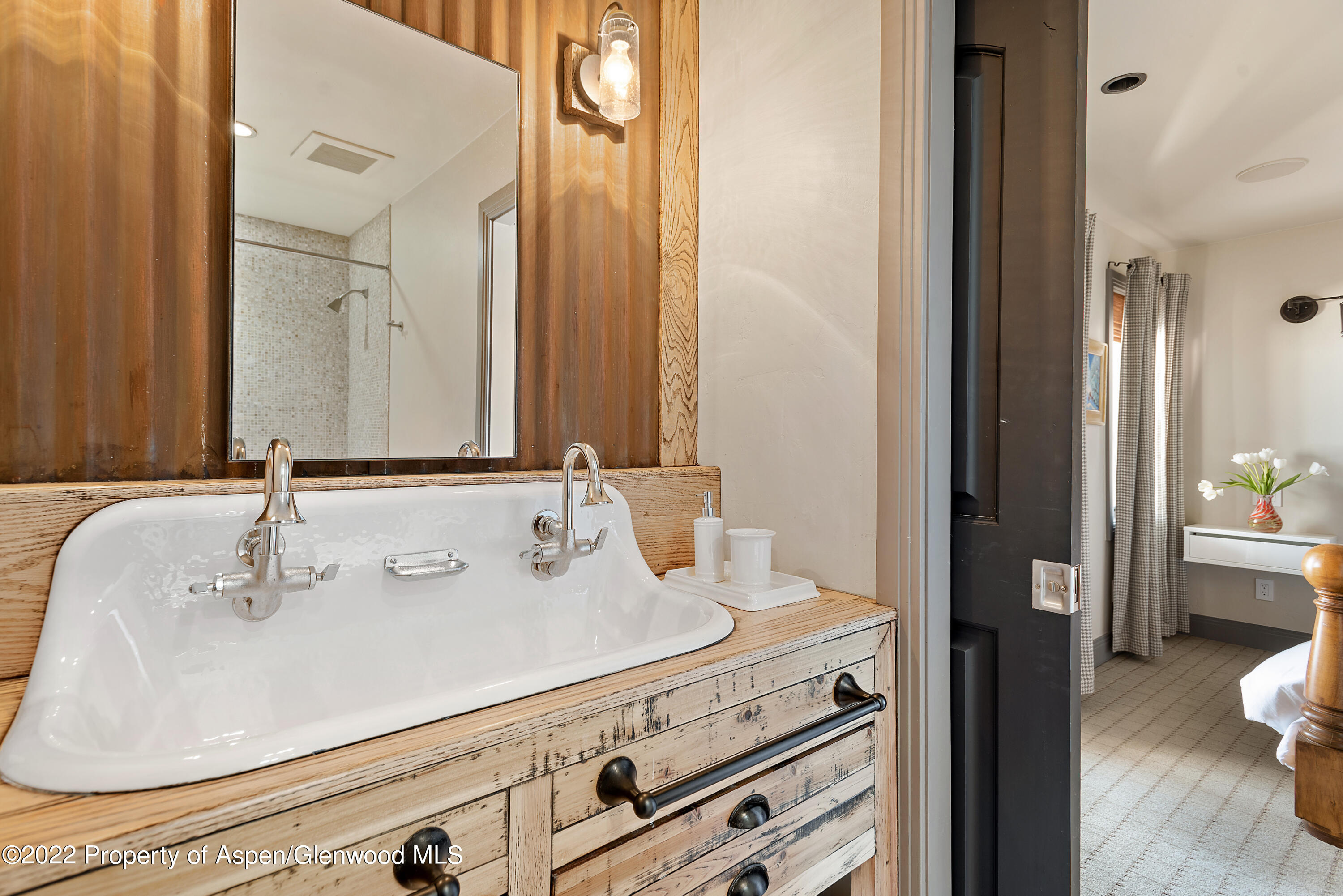 399 Maple Ridge Lane Snowmass Village, CO 81615 - Photo 22 of 27 a bathroom with a sink and a mirror with toilet