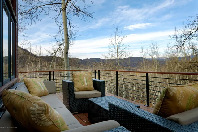 a view of balcony with wooden floor and fence