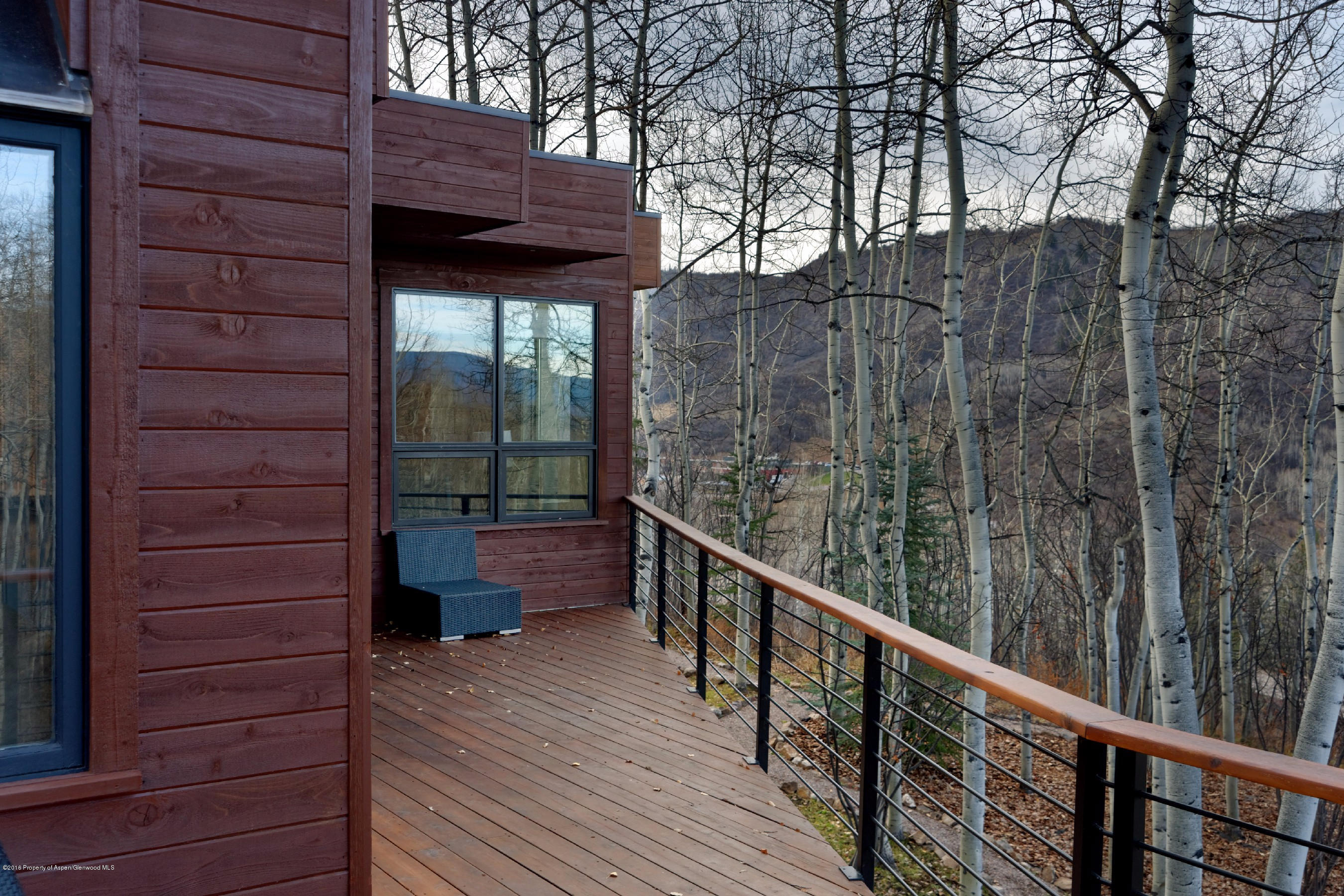 399 Maple Ridge Lane Snowmass Village, CO 81615 - Photo 25 of 27 a view of balcony with wooden floor and fence