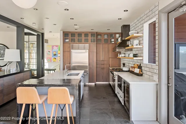 a kitchen with a stove a sink and cabinets