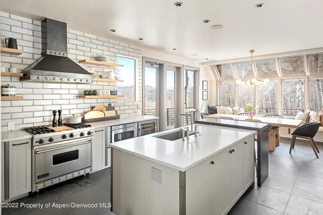 a view of a dining room with furniture large windows and wooden floor