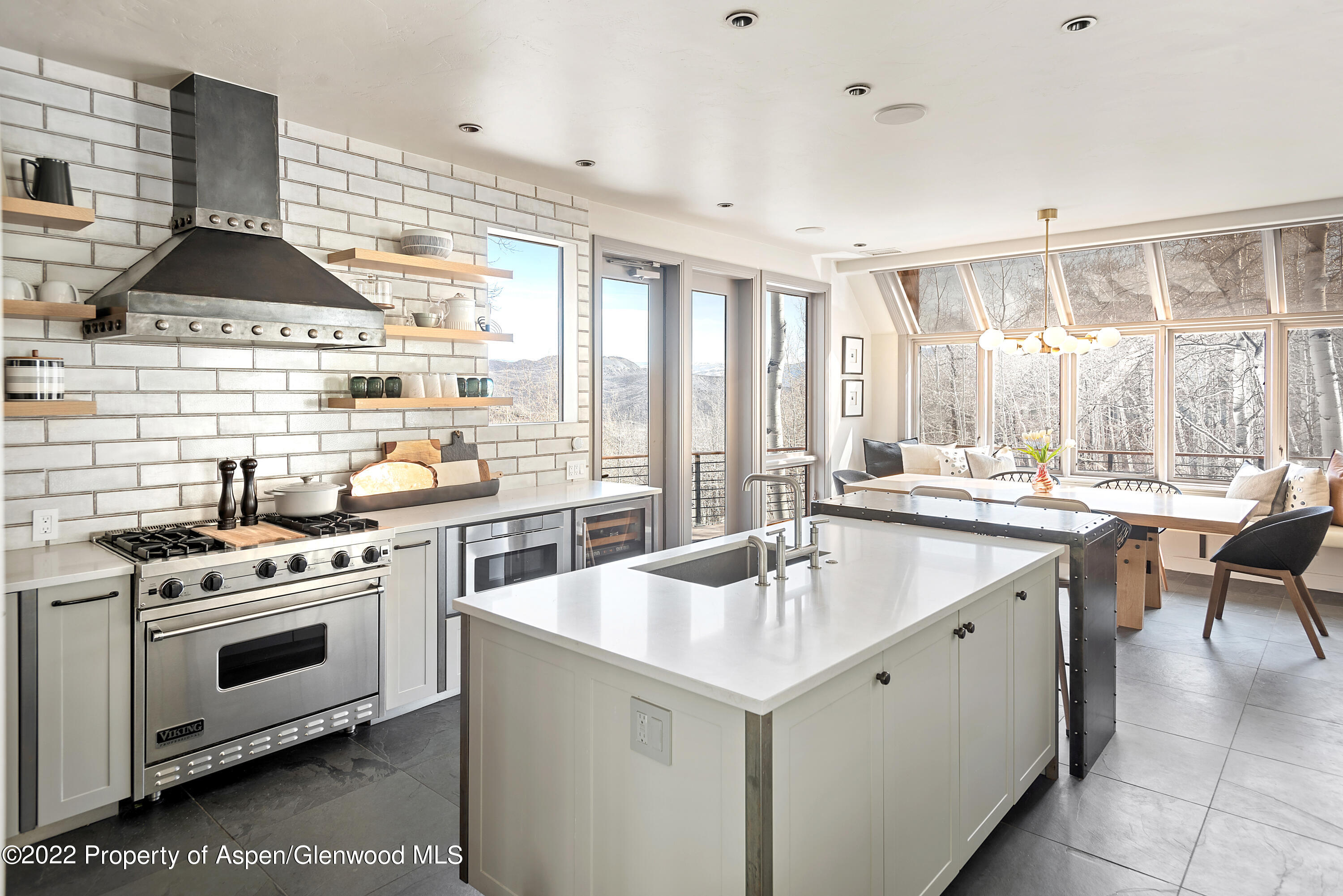 399 Maple Ridge Lane Snowmass Village, CO 81615 - Photo 5 of 27 a kitchen with a stove a sink and cabinets