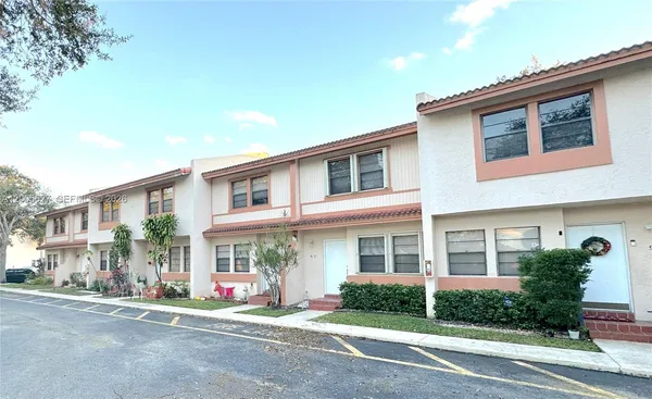 a front view of a residential apartment building with a yard
