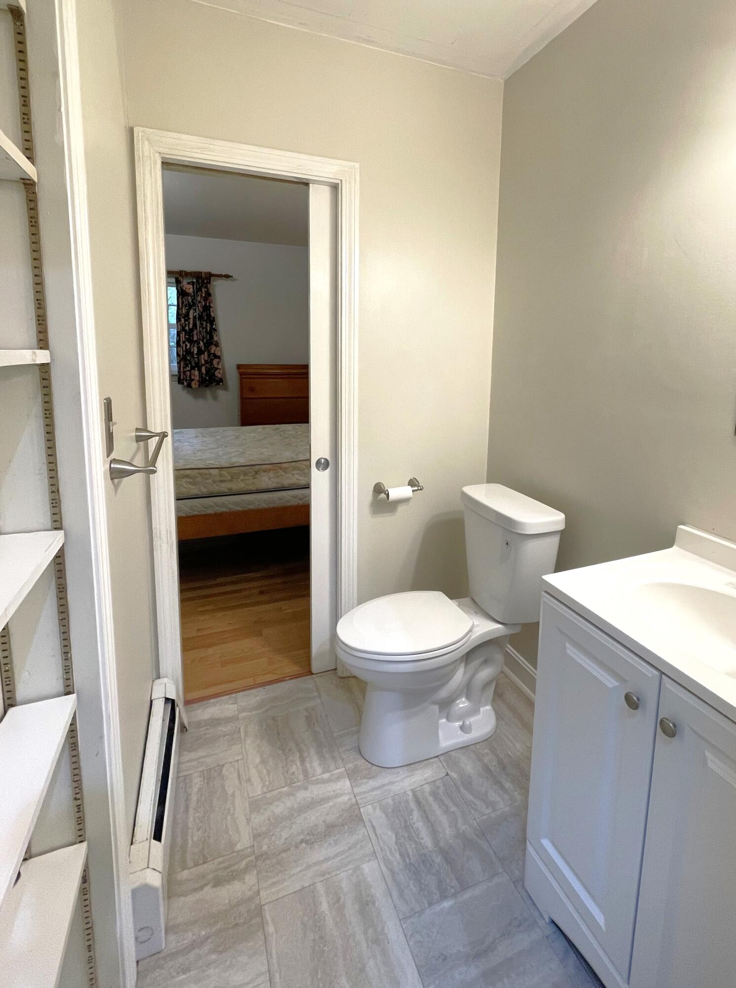 73 Tern Lane Centerville, MA 02632 - Photo 13 of 31 a white toilet sitting next to a bathroom sink