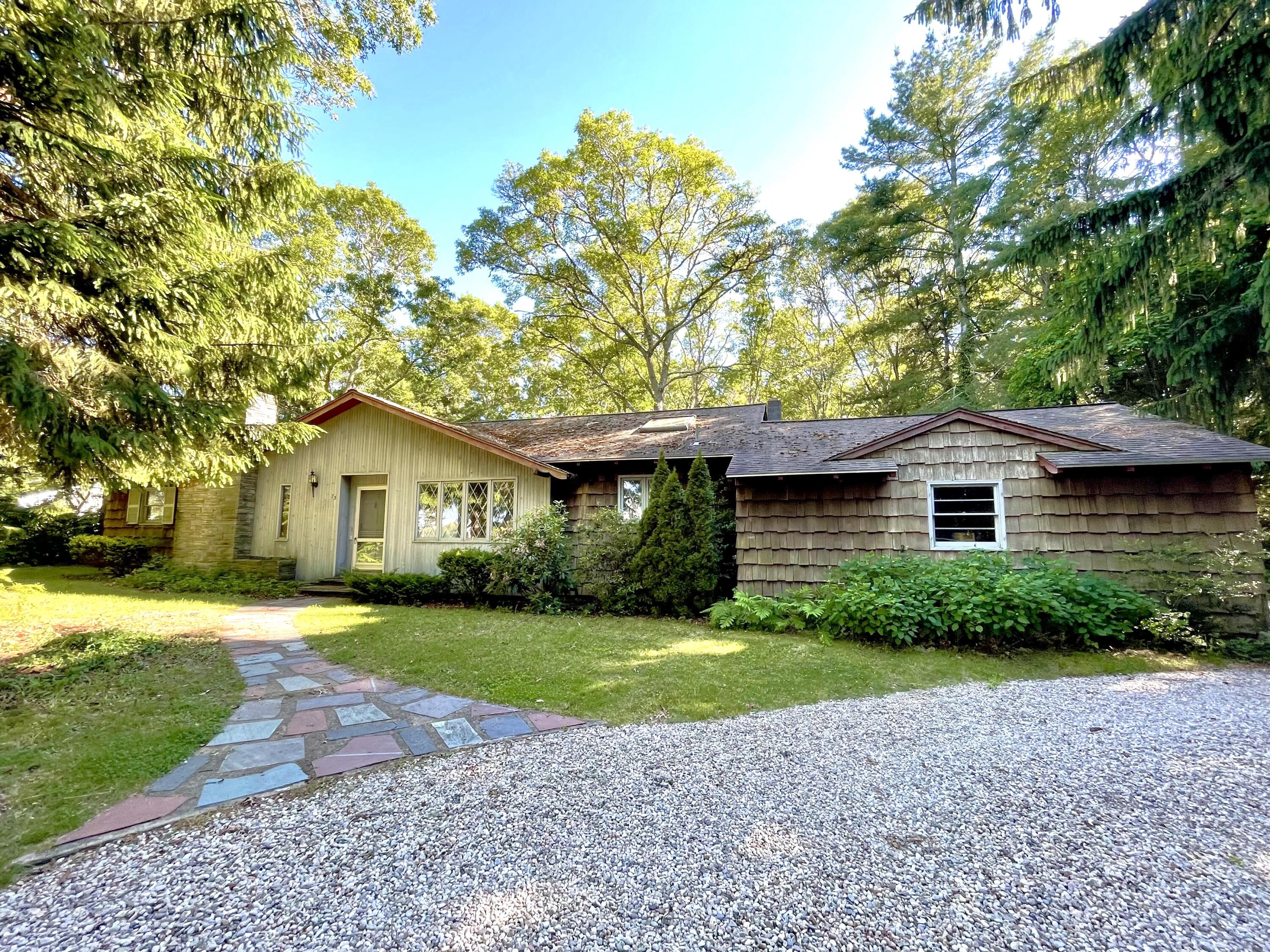 73 Tern Lane Centerville, MA 02632 - Photo 2 of 31 a front view of a house with a garden