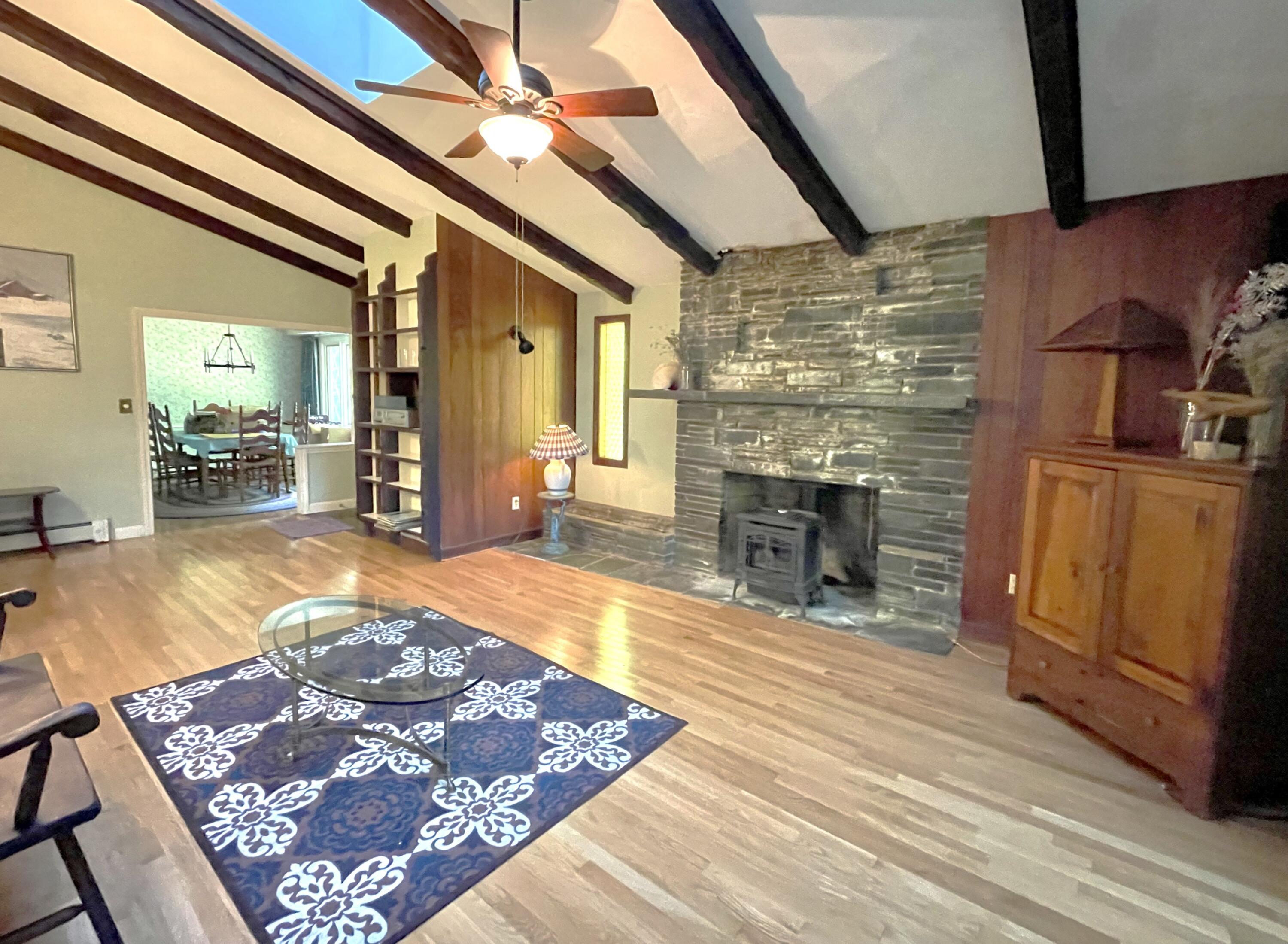 73 Tern Lane Centerville, MA 02632 - Photo 3 of 31 a living room with stainless steel appliances furniture a rug and a fireplace