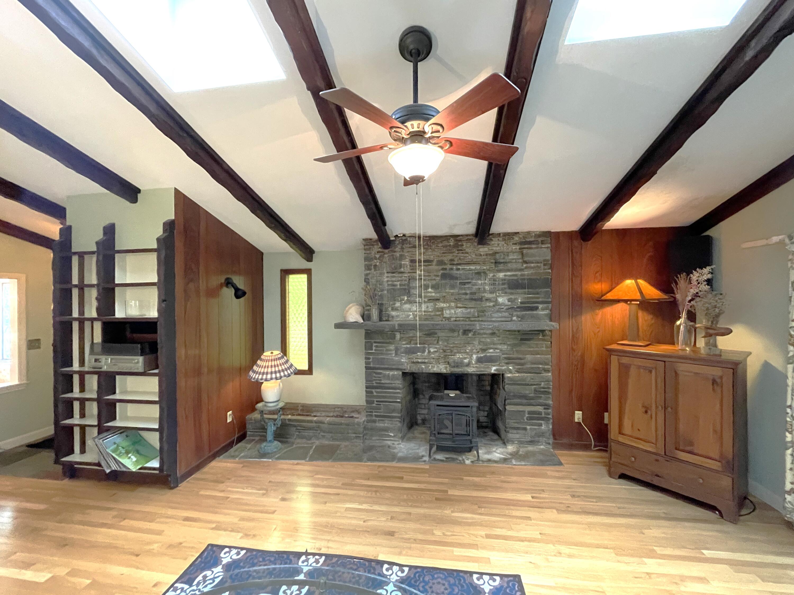 73 Tern Lane Centerville, MA 02632 - Photo 4 of 31 a view of empty room with wooden floor and fireplace