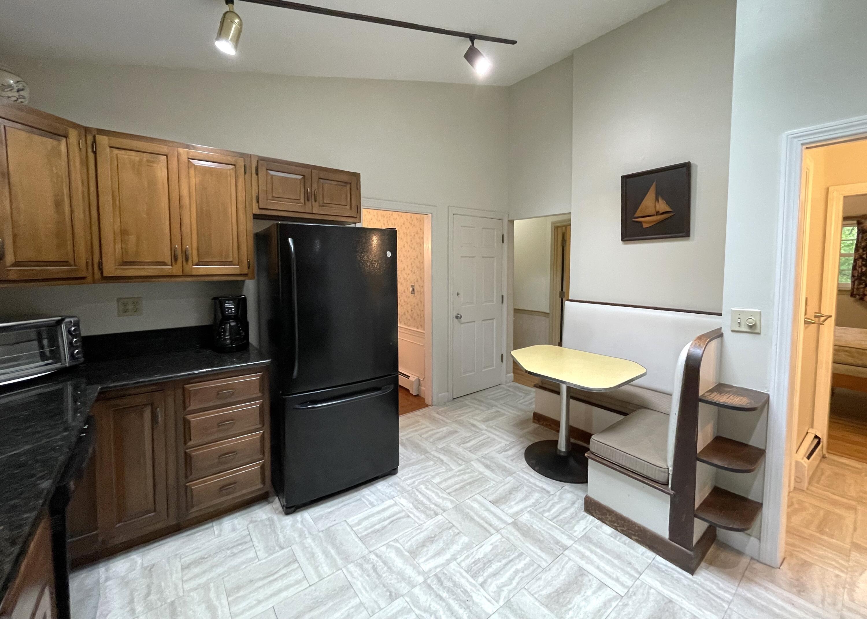 73 Tern Lane Centerville, MA 02632 - Photo 8 of 31 a kitchen with a refrigerator and a table