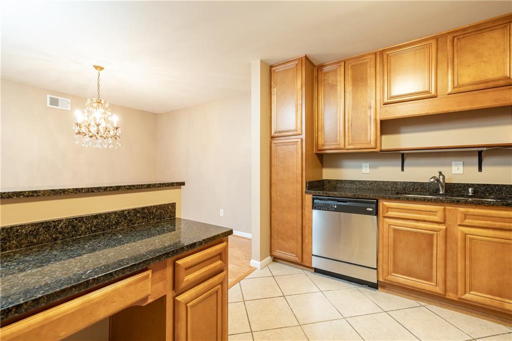 1468 Briarwood Road Northeast, Unit 1005 Atlanta, GA 30319 - Photo 12 of 45 a kitchen with stainless steel appliances granite countertop a sink and cabinets