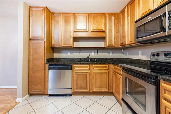 a kitchen with a stove a sink and a microwave