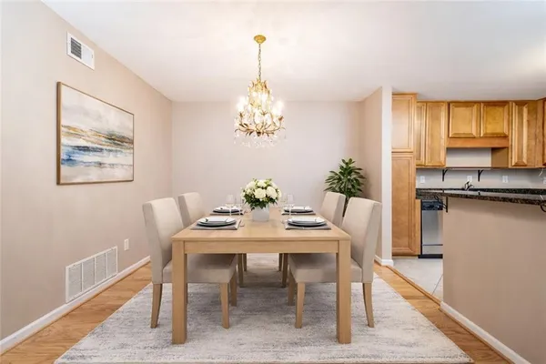 a view of a kitchen with wooden floor and a kitchen
