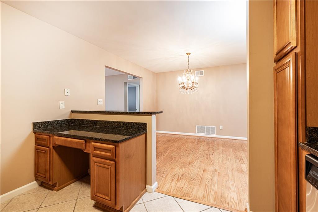1468 Briarwood Road Northeast, Unit 1005 Atlanta, GA 30319 - Photo 17 of 45 a kitchen with kitchen island a sink appliances and cabinets