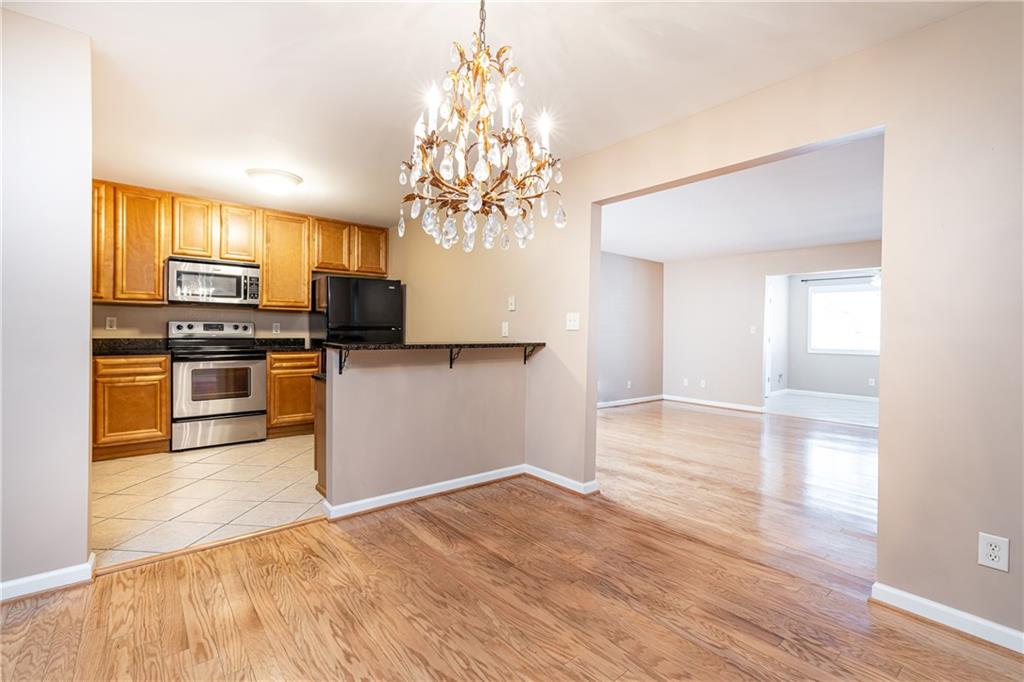 1468 Briarwood Road Northeast, Unit 1005 Atlanta, GA 30319 - Photo 18 of 45 a view of a kitchen with wooden floor and stainless steel appliances