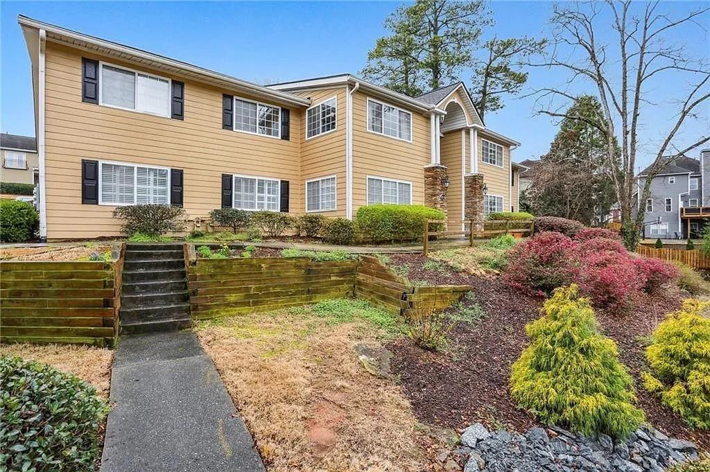 1468 Briarwood Road Northeast, Unit 1005 Atlanta, GA 30319 - Photo 2 of 45 a front view of a house with a yard