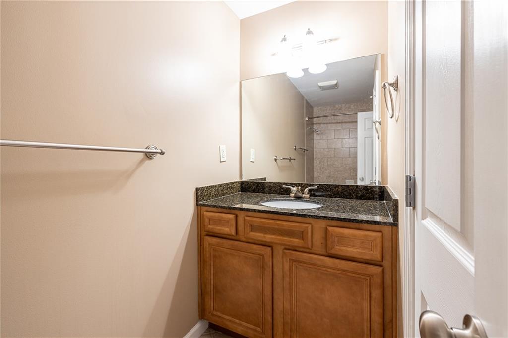 1468 Briarwood Road Northeast, Unit 1005 Atlanta, GA 30319 - Photo 32 of 45 a bathroom with a granite countertop sink and a mirror
