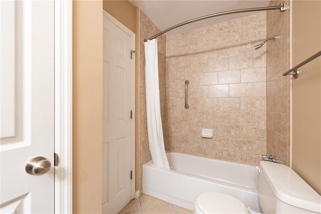 1468 Briarwood Road Northeast, Unit 1005 Atlanta, GA 30319 - Photo 36 of 45 a bathroom with a shower and a tub