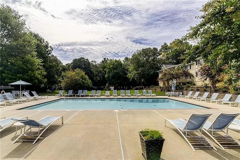 1468 Briarwood Road Northeast, Unit 1005 Atlanta, GA 30319 - Photo 44 of 45 a view of a swimming pool with lounge chairs