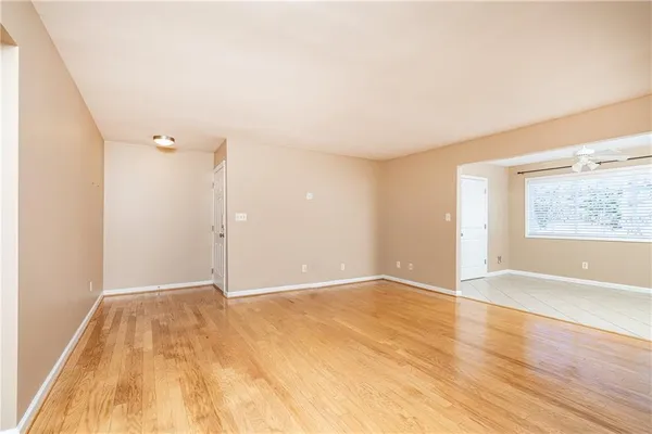a kitchen with kitchen island granite countertop white cabinets and refrigerator