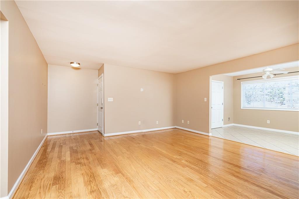 1468 Briarwood Road Northeast, Unit 1005 Atlanta, GA 30319 - Photo 10 of 45 a view of an empty room with wooden floor and a window