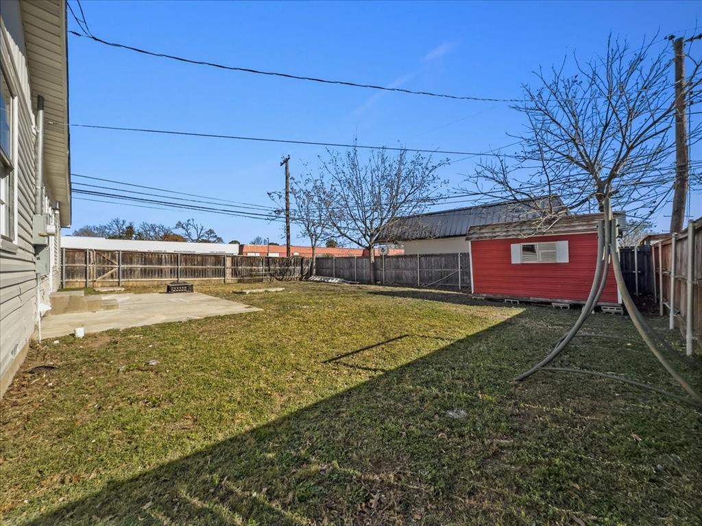1236 Harrison Lane Hurst, TX 76053 - Photo 20 of 25 a view of a backyard with a large tree
