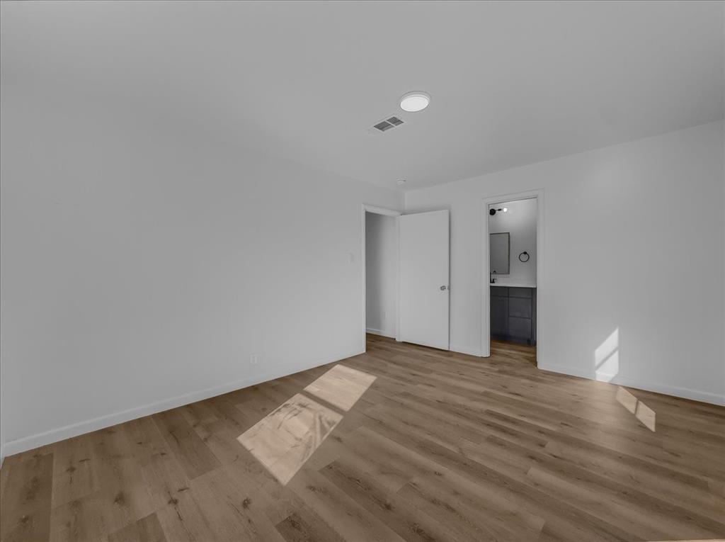 1236 Harrison Lane Hurst, TX 76053 - Photo 2 of 25 a view of an empty room with wooden floor and closet