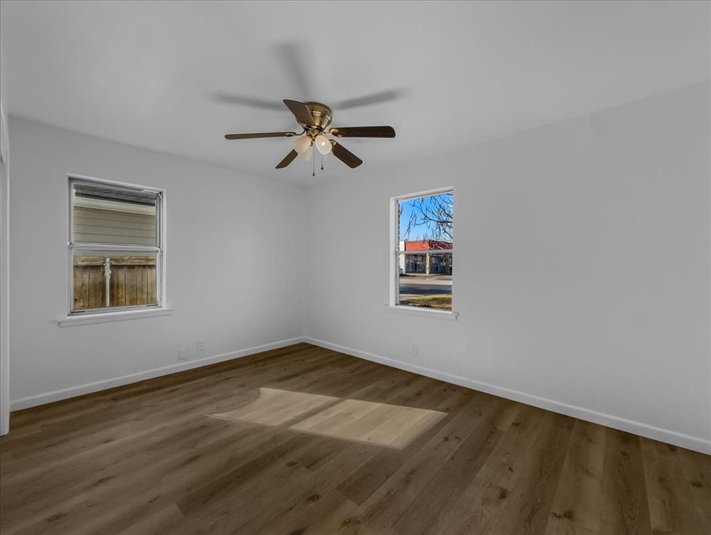 1236 Harrison Lane Hurst, TX 76053 - Photo 21 of 25 a view of a big room with wooden floor and windows
