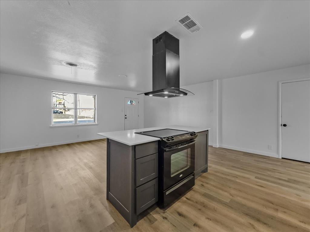 1236 Harrison Lane Hurst, TX 76053 - Photo 5 of 25 a view of kitchen with granite countertop cabinets and wooden floor