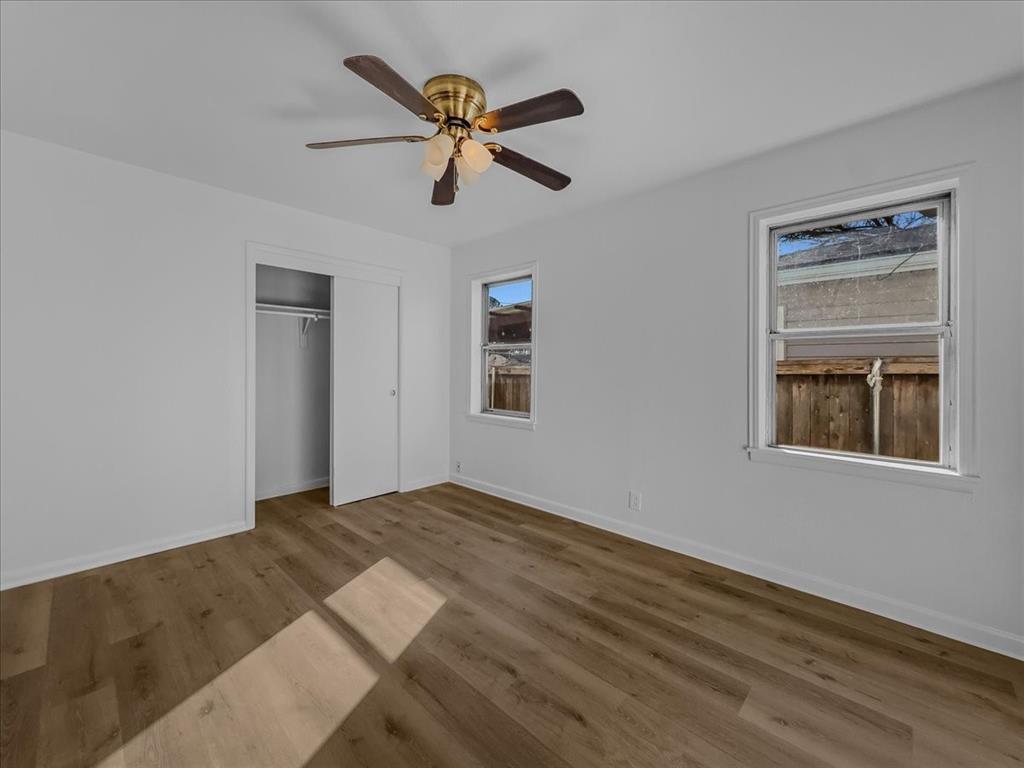1236 Harrison Lane Hurst, TX 76053 - Photo 9 of 25 a view of empty room with wooden floor and ceiling fan
