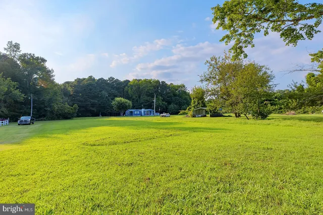 a view of a swimming pool with a yard
