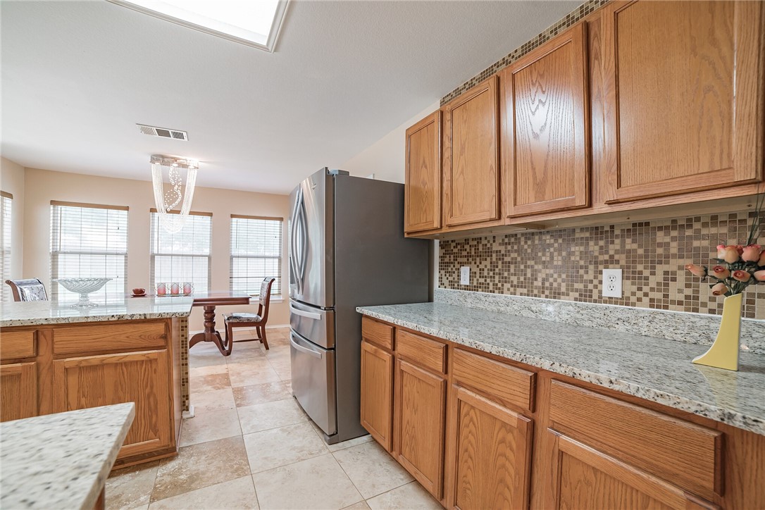 11228 Pickard Lane Austin, TX 78748 - Photo 12 of 32 a kitchen with stainless steel appliances granite countertop a stove refrigerator sink and cabinets