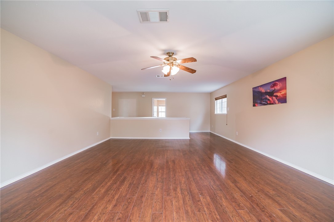 11228 Pickard Lane Austin, TX 78748 - Photo 18 of 32 a view of empty room with wooden floor and fan